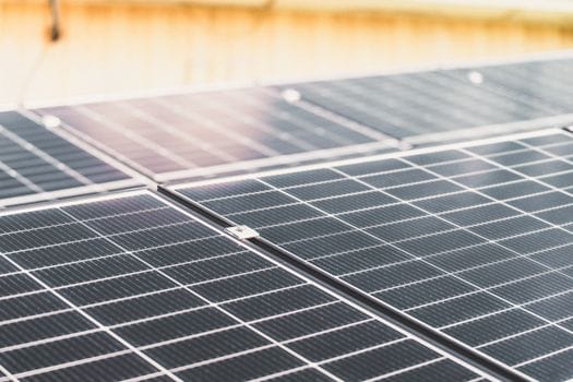 Solar panel close up with sun glaring on it.