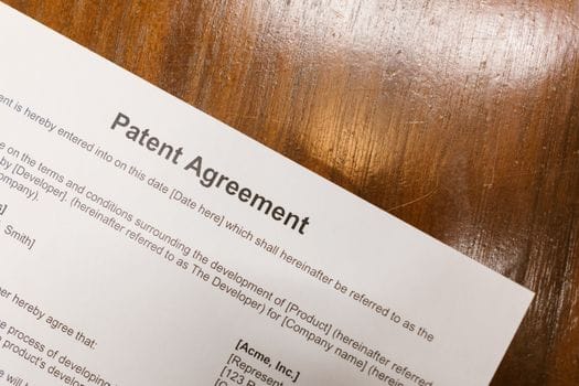 solar contract paperwork, that says Patent Agreement, paperwork on a desk.